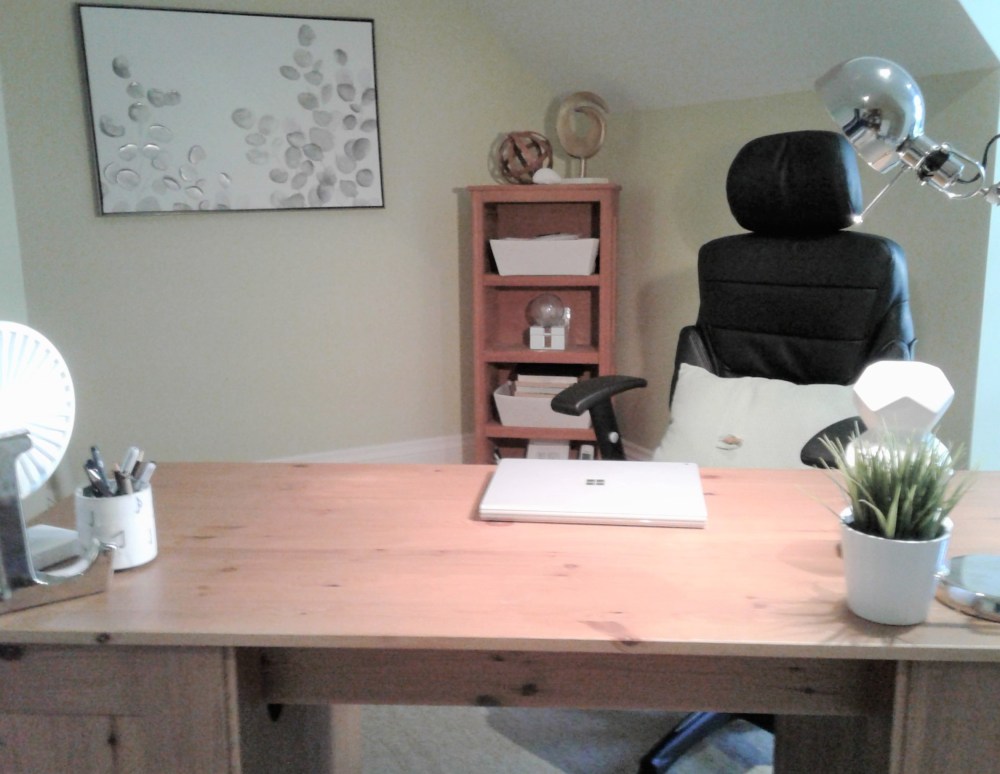 Home office spring cleaning includes replacing winter decor with spring decor. In the home office it can mean adding spring themed wall art such as the wall art in this home office. It can also mean replacing dark coloured winter throw pillows with pastel green ones such as pictured  on this office chair.