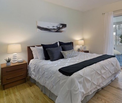 Vintage mid-century modern furniture made contemporary by contemporary accessories. I recommended that the owners painted the room in a warm white which they did. It  helps give it that updated look.