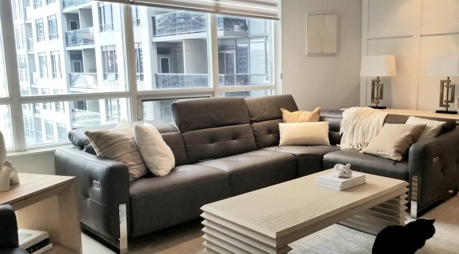 Condo living room redecorated and redesigned by Lynteriors with a whitewashed coffee table, console table, natural stained side table and cat friendly sandy coloured rug.